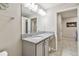 Clean bathroom with granite countertop, framed mirror, and tile flooring, offers a functional and stylish space at 3886 Reflection Dock Dr, Seffner, FL 33584
