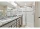 Bright bathroom offering a double-sink vanity with granite countertops and an enclosed shower at 3886 Reflection Dock Dr, Seffner, FL 33584