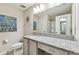 Well-lit bathroom with granite countertop, framed mirror, and a walk-in shower, creating a clean and functional space at 3886 Reflection Dock Dr, Seffner, FL 33584
