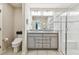 Clean bathroom featuring a double-sink vanity, and tiled walk-in shower at 3886 Reflection Dock Dr, Seffner, FL 33584