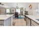 Open dining area with modern lighting, view into living room, and wet bar at 3886 Reflection Dock Dr, Seffner, FL 33584