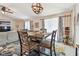 Open dining room with modern chandelier, dark wood table and chairs, and sliding glass doors at 3886 Reflection Dock Dr, Seffner, FL 33584