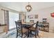 Cozy dining area with decorative lighting fixture, bar and beverage station, and neutral-colored tile flooring at 3886 Reflection Dock Dr, Seffner, FL 33584