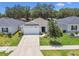 Charming single-story home with a well-manicured front yard, a two car garage, and inviting curb appeal at 3886 Reflection Dock Dr, Seffner, FL 33584