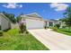 Charming single-Gathering home boasts a well-maintained lawn, complemented by lush landscaping, enhancing its curb appeal at 3886 Reflection Dock Dr, Seffner, FL 33584
