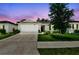 Charming single-Gathering home features a manicured lawn, mature tree, and neutral paint scheme, creating an inviting curb appeal at 3886 Reflection Dock Dr, Seffner, FL 33584