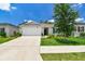Inviting single-Gathering home with a well-kept lawn and mature tree, offering a serene and welcoming curb appeal at 3886 Reflection Dock Dr, Seffner, FL 33584