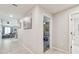 Bright hallway with tile flooring gives way to a living area and bedroom, creating an inviting flow throughout the home at 3886 Reflection Dock Dr, Seffner, FL 33584