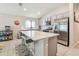 Modern kitchen features a spacious island with bar stool seating and stainless steel appliances at 3886 Reflection Dock Dr, Seffner, FL 33584