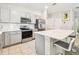 Well-lit kitchen boasts stainless steel appliances, an island with barstool seating, and subway tile backsplash at 3886 Reflection Dock Dr, Seffner, FL 33584
