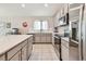 Well-lit kitchen featuring stainless steel appliances and center island with a white countertop at 3886 Reflection Dock Dr, Seffner, FL 33584