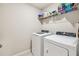 Clean laundry room features a modern washer and dryer with wire shelving above at 3886 Reflection Dock Dr, Seffner, FL 33584