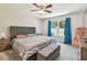 Stylish bedroom with a padded headboard and foot bench with bright, natural light at 3886 Reflection Dock Dr, Seffner, FL 33584