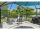 Screened patio with a fire pit and Adirondack chairs; perfect for outdoor gatherings at 4009 Clear Spring Rd, Brooksville, FL 34604