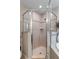 Neutral toned shower with glass doors and silver trim at 4009 Clear Spring Rd, Brooksville, FL 34604