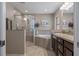 Elegant bathroom featuring a walk-in shower, a garden tub, and tasteful decorative touches at 4009 Clear Spring Rd, Brooksville, FL 34604
