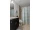 Bathroom showcasing a single sink vanity with modern finishes and a shower with a patterned shower curtain at 4009 Clear Spring Rd, Brooksville, FL 34604