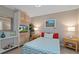 This is a bedroom with a queen size bed and a small desk with a chair, all illuminated by natural light at 4009 Clear Spring Rd, Brooksville, FL 34604