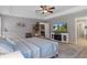 Inviting bedroom with a ceiling fan, tray ceilings, and an adjacent bathroom at 4009 Clear Spring Rd, Brooksville, FL 34604