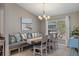 Bright dining area with a built-in banquette, a wooden table, and a large window at 4009 Clear Spring Rd, Brooksville, FL 34604