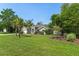 Well-manicured home with a large green lawn, framed by lush landscaping and trees at 4009 Clear Spring Rd, Brooksville, FL 34604