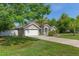 Charming home with well-kept lawn and mature trees, enhanced by a paved driveway at 4009 Clear Spring Rd, Brooksville, FL 34604