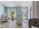 Inviting Foyer features cool colors, light tile flooring, decorative front door and an ornate chair with a patterned rug at 4009 Clear Spring Rd, Brooksville, FL 34604