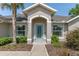 Charming front entrance with a decorative glass door and manicured landscaping at 4009 Clear Spring Rd, Brooksville, FL 34604