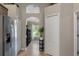Hallway view with multiple closets, an arched window, and access to the kitchen at 4009 Clear Spring Rd, Brooksville, FL 34604