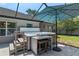 Relaxing backyard with a covered hot tub, outdoor seating, and umbrella for shade at 4009 Clear Spring Rd, Brooksville, FL 34604