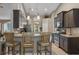Modern kitchen featuring dark cabinets, stainless steel appliances, and a breakfast bar at 4009 Clear Spring Rd, Brooksville, FL 34604