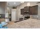 Well-equipped kitchen with dark wood cabinets, a granite countertop, and stainless steel appliances at 4009 Clear Spring Rd, Brooksville, FL 34604