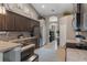 Spacious kitchen with ample dark wood cabinetry, stainless appliances, and a view to the hallway at 4009 Clear Spring Rd, Brooksville, FL 34604