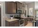 Modern kitchen featuring dark cabinets, stainless steel appliances, and a breakfast bar at 4009 Clear Spring Rd, Brooksville, FL 34604