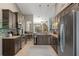 Open kitchen with stainless steel appliances, dark cabinetry, and a view of the dining area at 4009 Clear Spring Rd, Brooksville, FL 34604