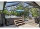 Outdoor patio with hot tub, umbrella, dining area, and fenced-in yard at 4009 Clear Spring Rd, Brooksville, FL 34604