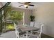 Covered patio area with dining table, ceiling fan, and lush outdoor view at 4009 Clear Spring Rd, Brooksville, FL 34604