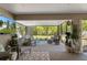Beautiful screened-in patio with outdoor seating, hot tub, and lovely views of the backyard at 4009 Clear Spring Rd, Brooksville, FL 34604