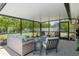 Spacious screened patio with plush furniture, tranquil backyard views, and an inviting atmosphere at 4009 Clear Spring Rd, Brooksville, FL 34604