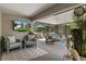 Comfortable screened patio with modern furniture, decor, television, and hot tub overlooking the yard at 4009 Clear Spring Rd, Brooksville, FL 34604