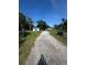 Gravel driveway leading to a property with well-maintained yard, providing ample parking space at 410 Houle Ave, Sarasota, FL 34232