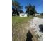 Property exterior featuring a gravel driveway, well-kept lawn, and ample parking at 410 Houle Ave, Sarasota, FL 34232