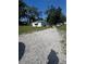Exterior view of the property with a gravel driveway and well-maintained yard at 410 Houle Ave, Sarasota, FL 34232