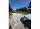Large front yard with gravel driveway and some grass; car parked in the drive at 410 Houle Ave, Sarasota, FL 34232