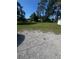 Large lot dotted with mature trees and lush green grass, perfect for outdoor activities at 410 Houle Ave, Sarasota, FL 34232