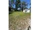 Spacious yard with mature trees and lush green grass, perfect for outdoor activities at 410 Houle Ave, Sarasota, FL 34232