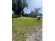 Expansive grassy yard with mature landscaping offering privacy at 410 Houle Ave, Sarasota, FL 34232