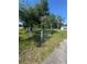 Fenced yard with mature landscaping and a well-maintained lawn, offering privacy and charm at 410 Houle Ave, Sarasota, FL 34232