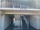 Condo exterior featuring second story balcony, stairs, and covered walkways at 4726 Marine Pkwy # 104, New Port Richey, FL 34652