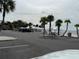 View of a parking lot at the beach with covered picnic tables near the water at 4726 Marine Pkwy # 104, New Port Richey, FL 34652